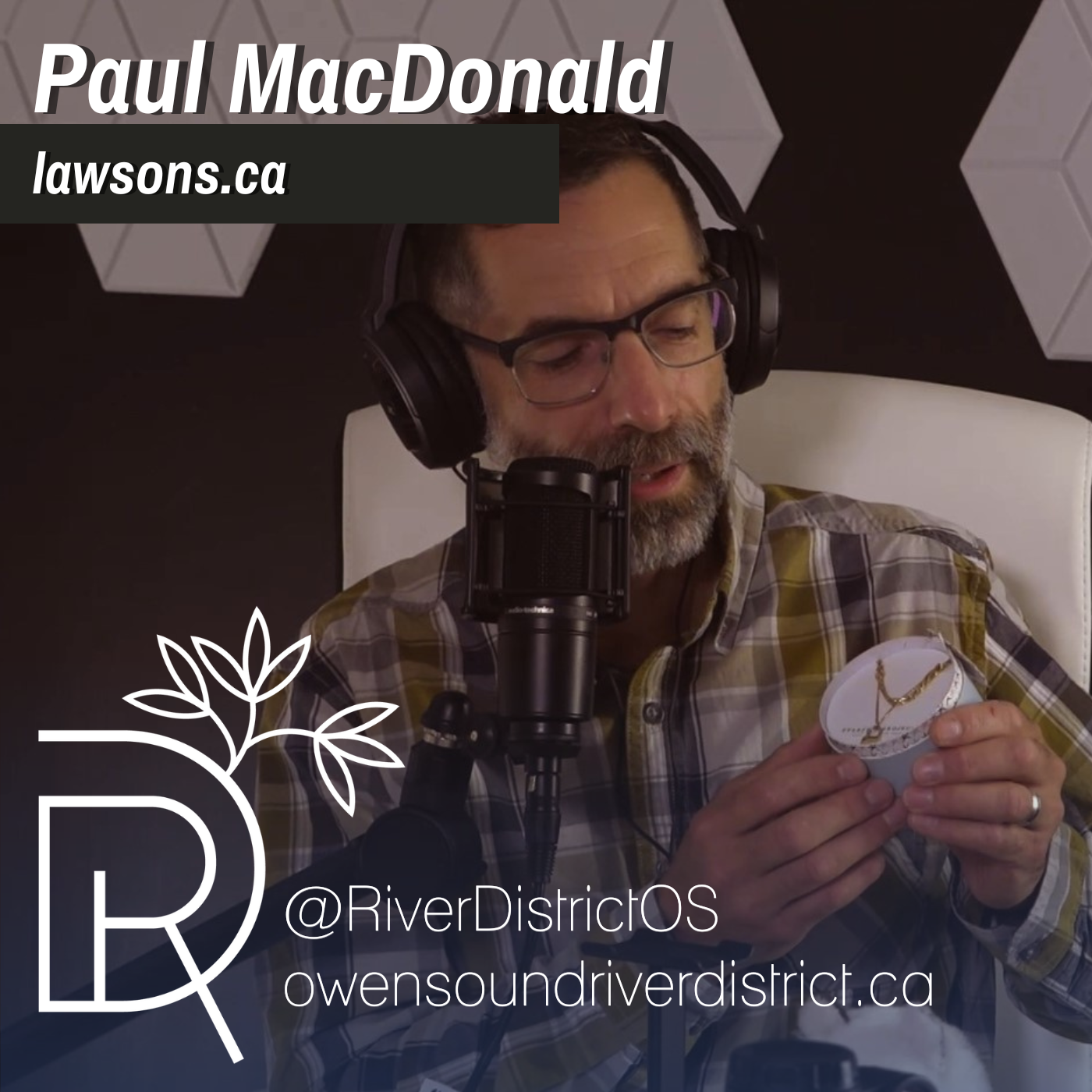 Photo of Paul macdonald of lawson's in front of a podcast microphone