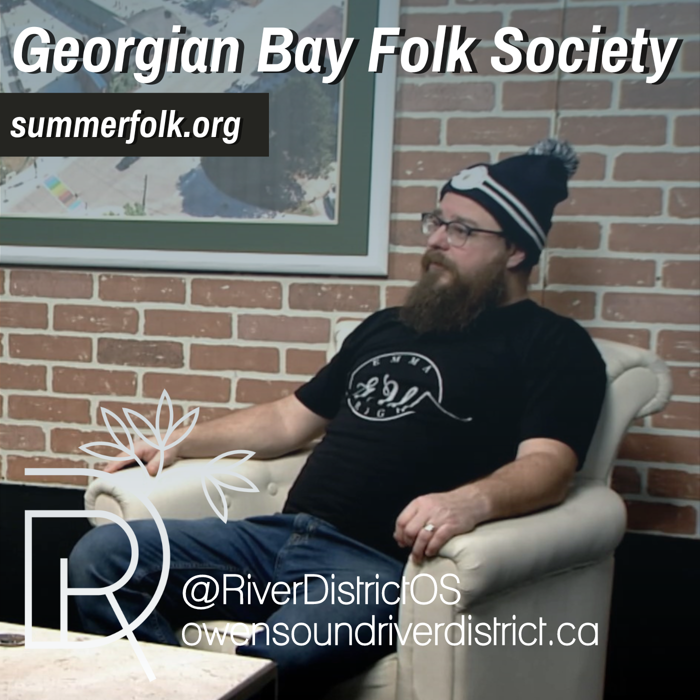 Jaret Koop in white chair against faux brick wall and white large picture frame