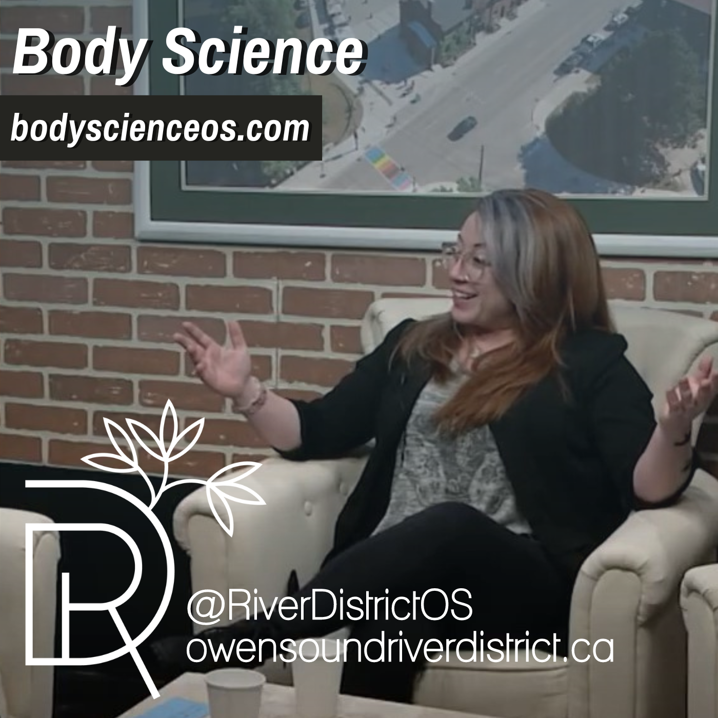 tasha tupper in white chair with faux brick background