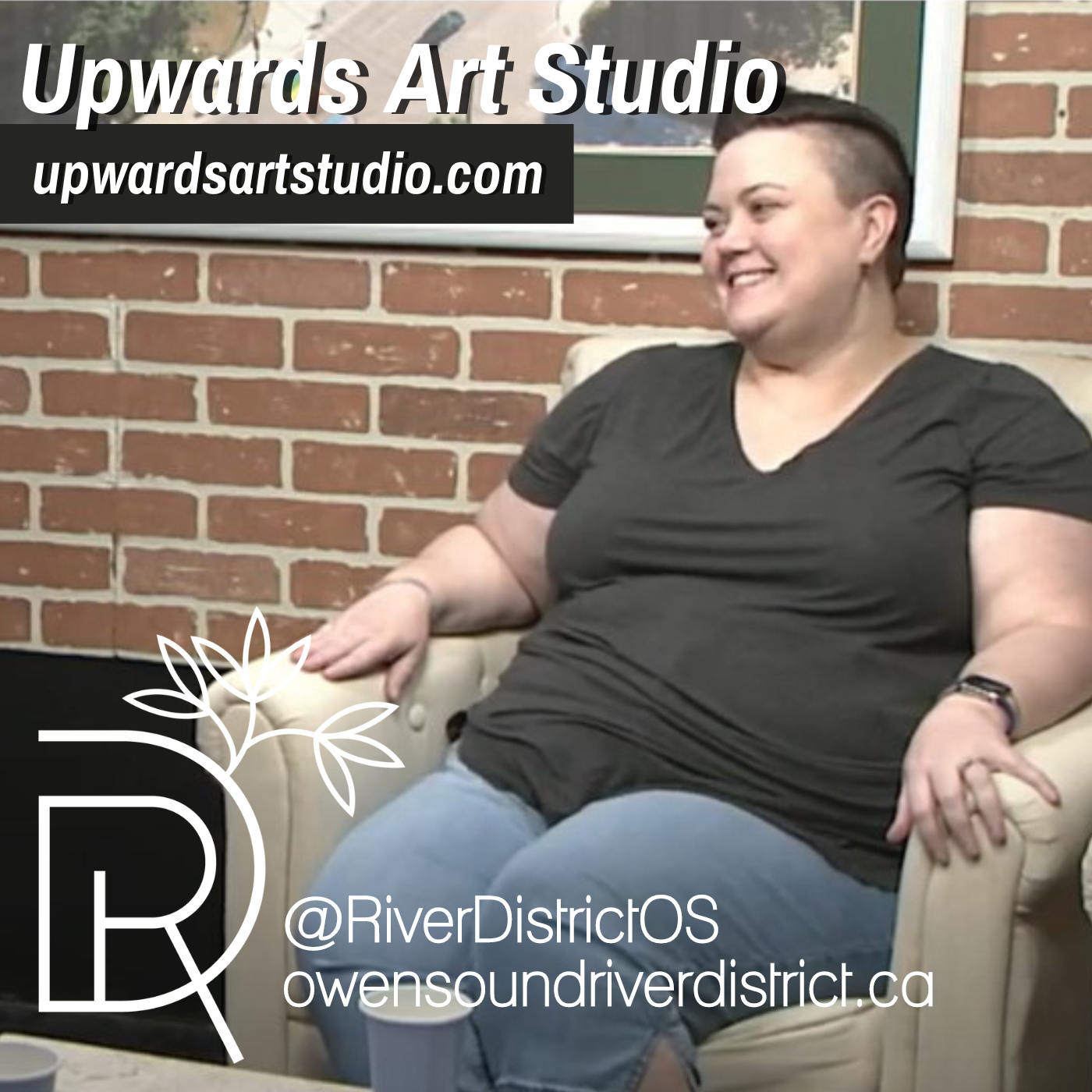 Amelia Kraemer of upwards art studio in a white chair with faux brick bakground